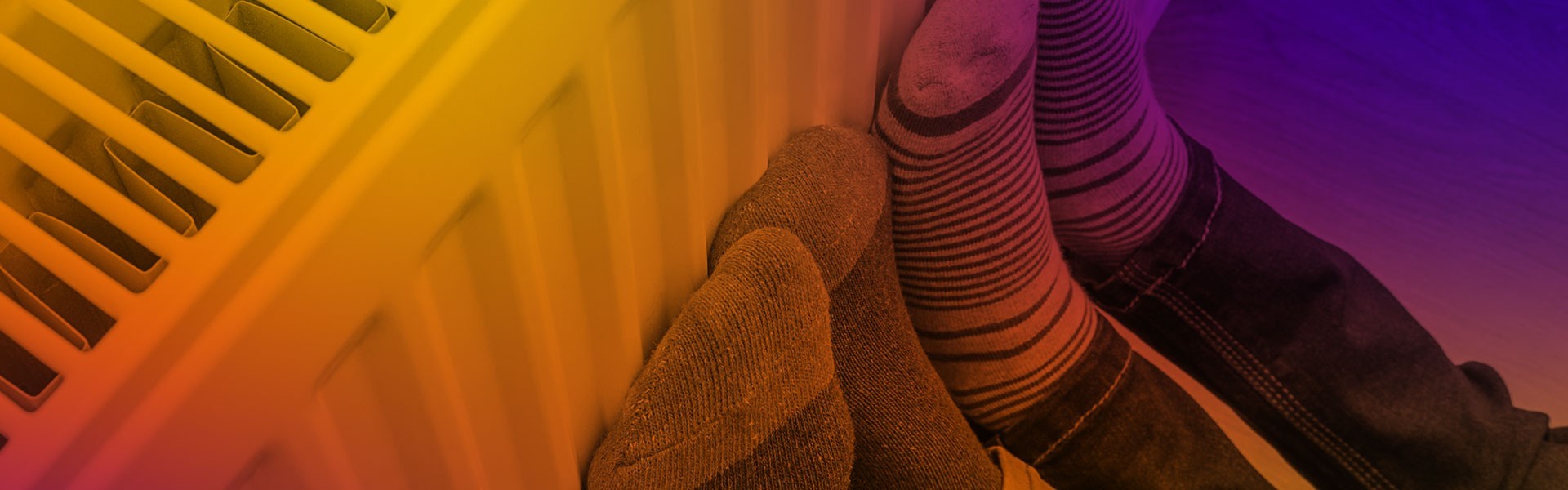 Kids warming feet on a radiator