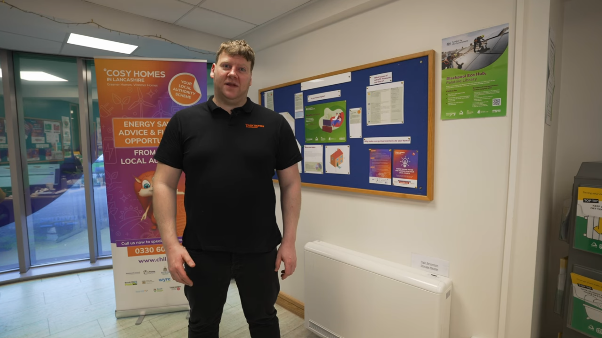 Cosy Homes team member talking with a High Heat Retention Storage Heater