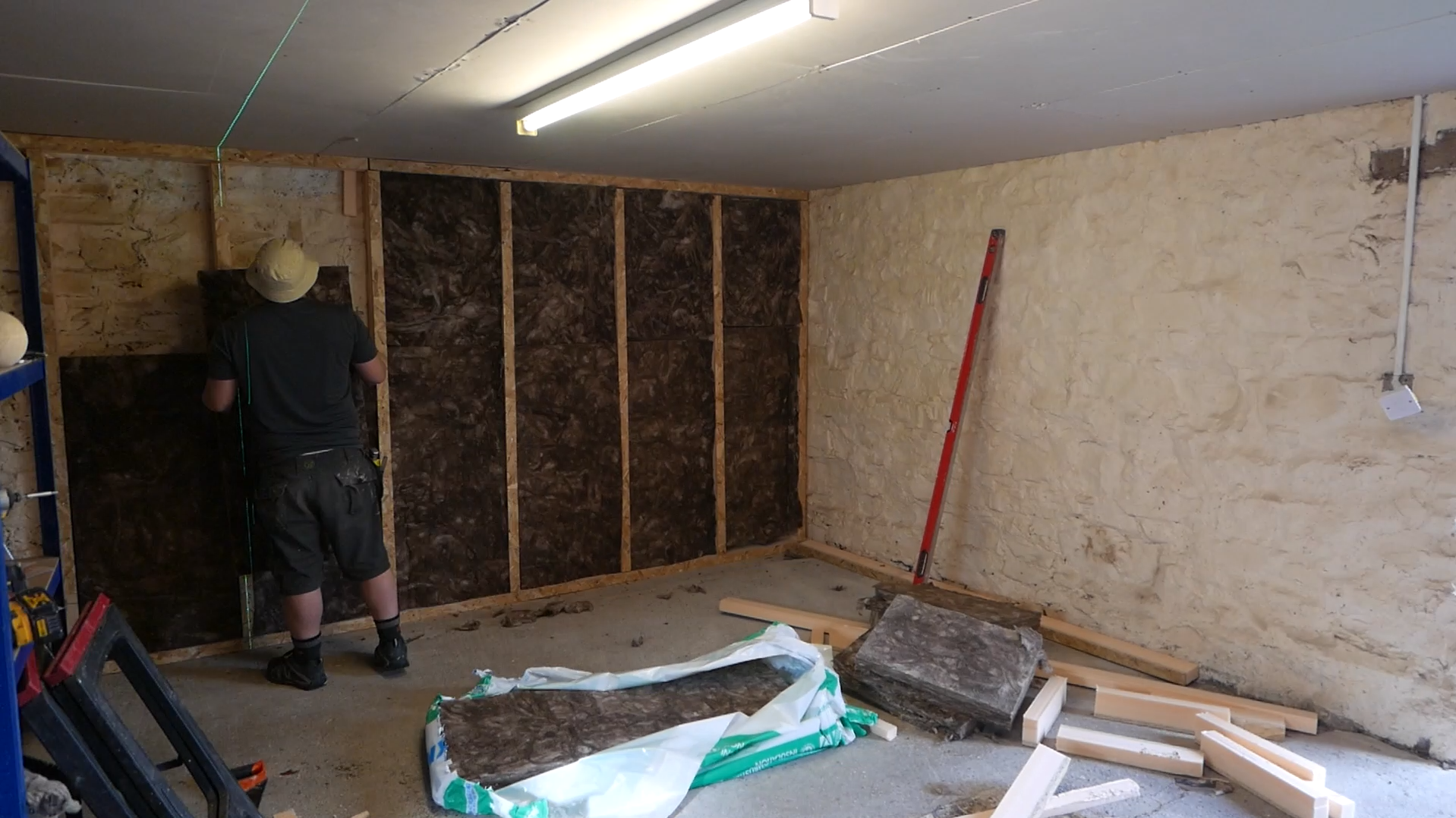 Builder installing internal wall insulation