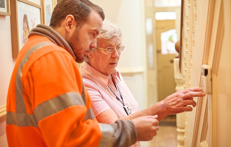 Heating Engineer With Old Lady