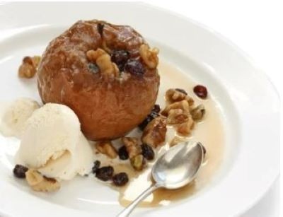 Baked apples stuffed with fruit and a scoop of vanilla ice cream