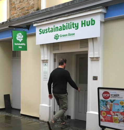 Person walking in to Green Rose CIC