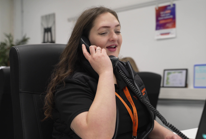 Cosy Homes staff member talking to a Lancashire resident on the phone